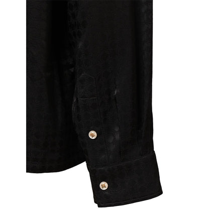 Close-up of the button cuff on the long sleeve of the Amiri MA Quad viscose notched collar shirt.
