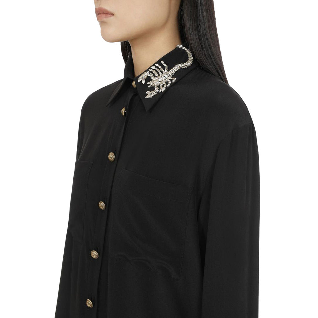 Close up detail of crystal scorpion embroidery on Balmain black silk shirt.