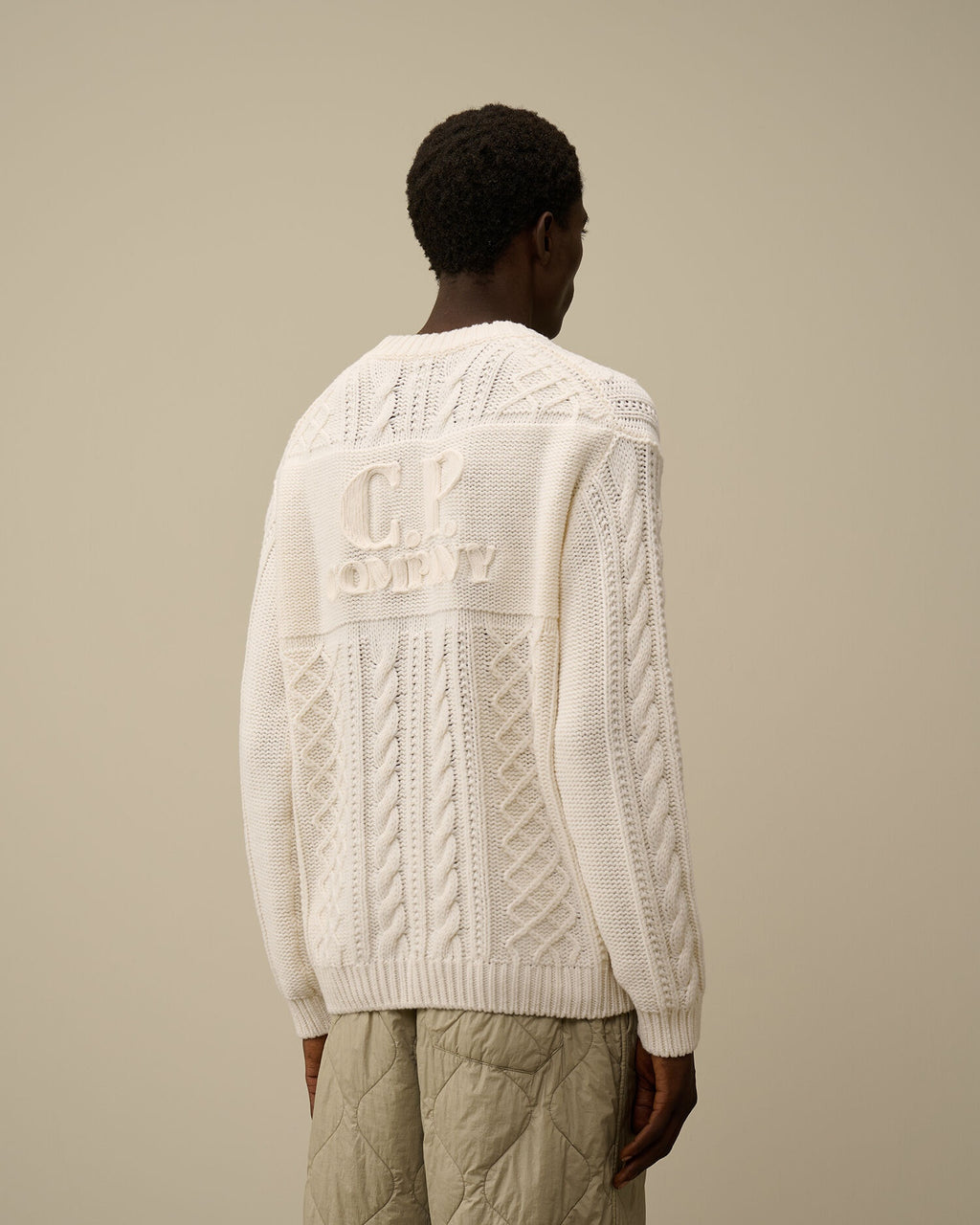 CP Company cream white cable-knit wool-blend sweater with front embroidered logo.
