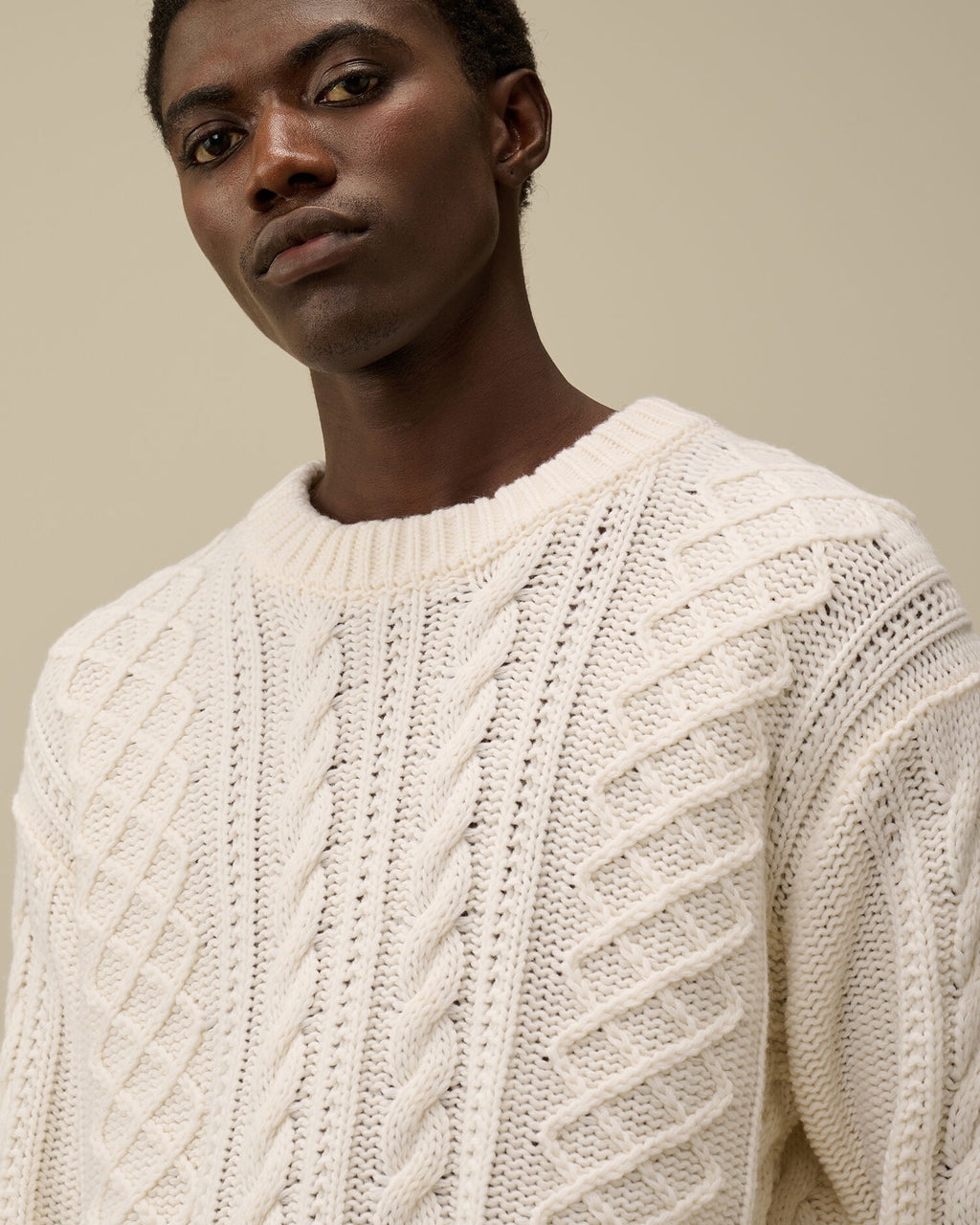 CP Company cream white cable-knit wool-blend sweater with embroidered logo, close view
