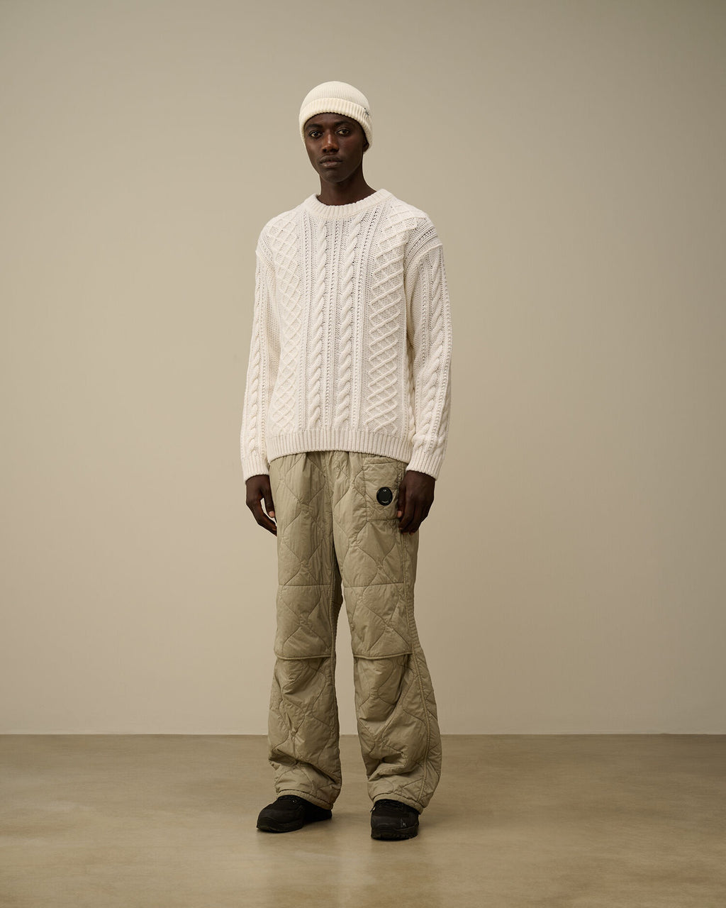 CP Company cream white cable-knit wool-blend sweater with embroidered logo on model