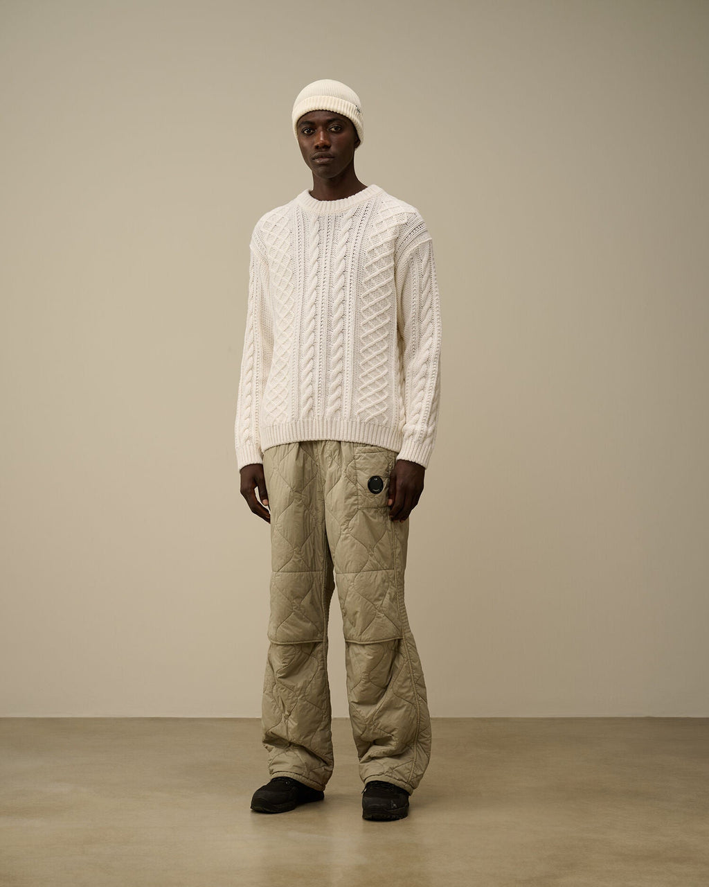 CP Company cream white cable-knit wool-blend sweater with embroidered logo on model