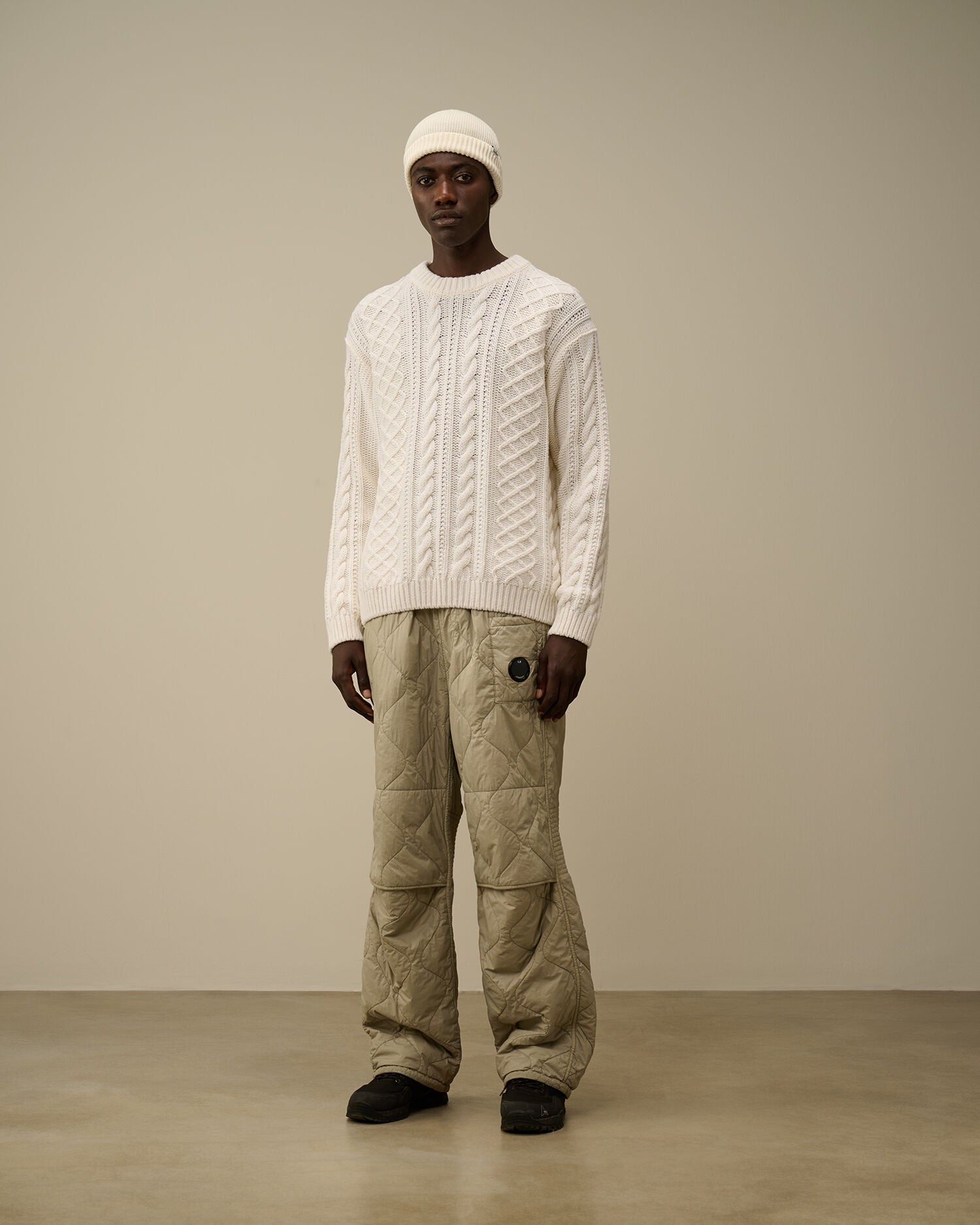 CP Company cream white cable-knit wool-blend sweater with embroidered logo on model