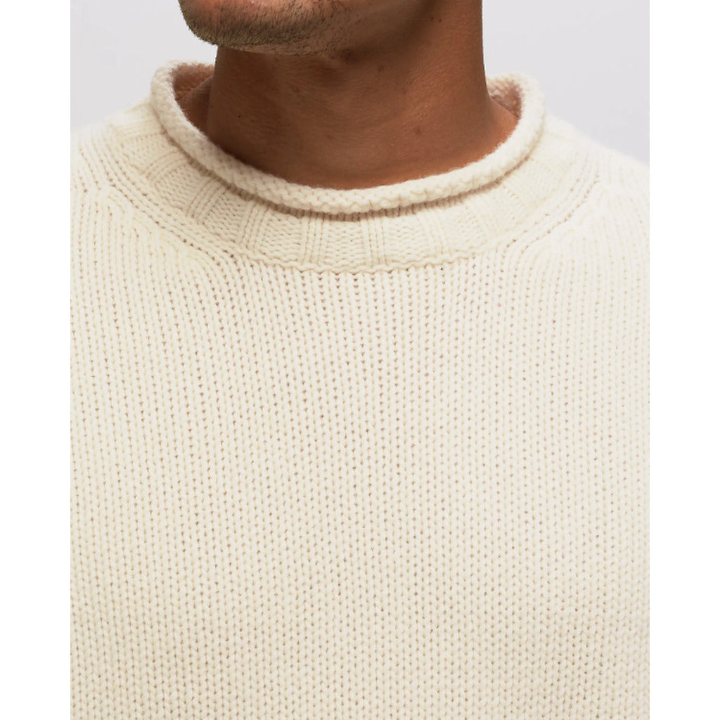 View of the crew neck and side buttoned goggle pocket on the CP Company cream white sweater.
