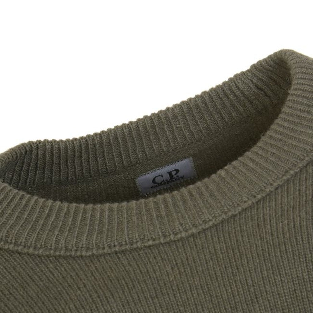 View of the crew neck and side zip goggle pocket on the CP Company green wool blend sweater