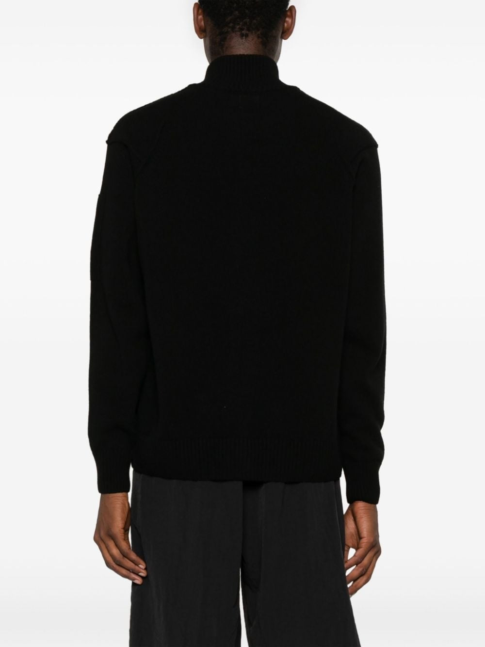 CP Company black labswool lens-detailed zipped cardigan sweater, back view.
