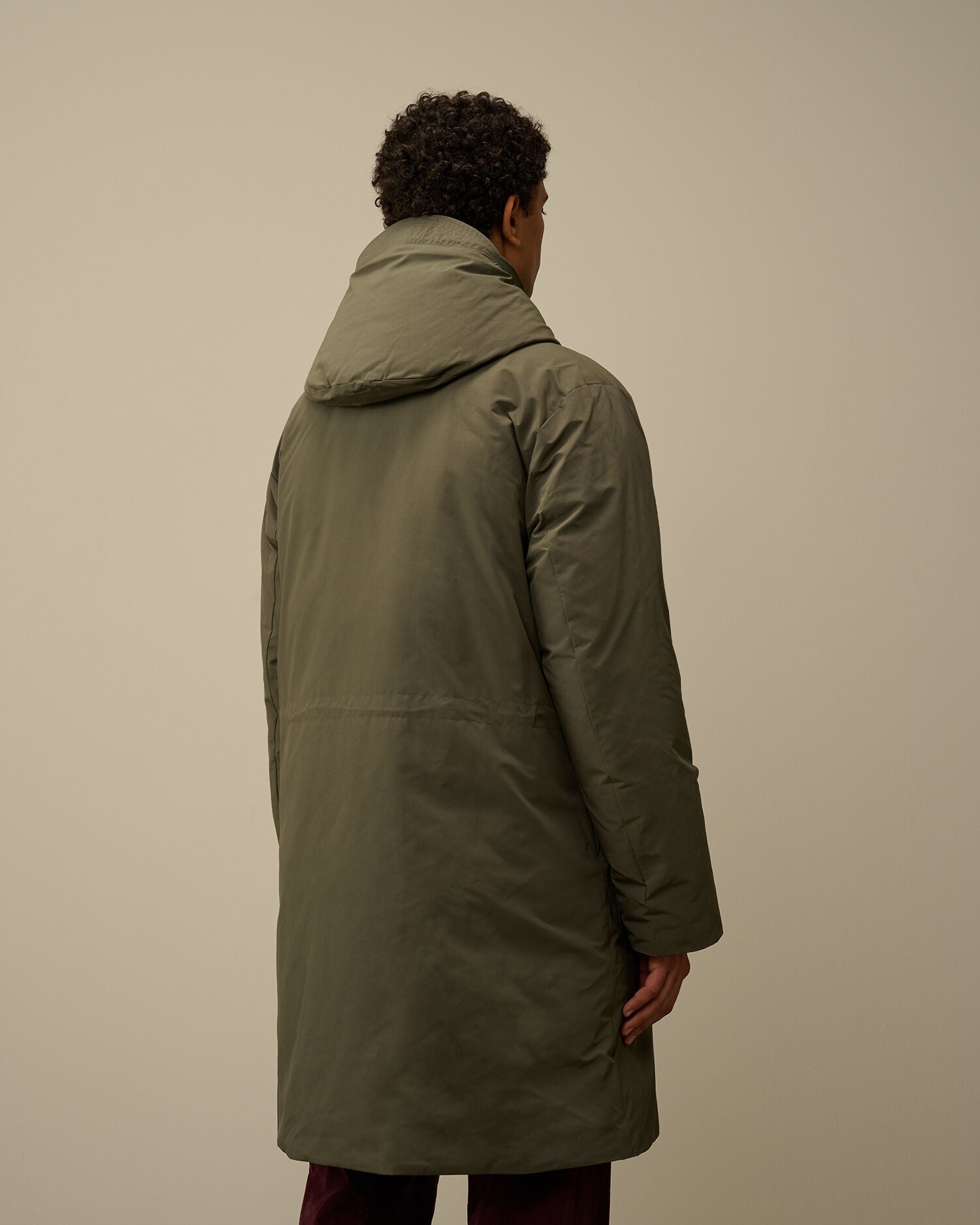 Back view of the CP Company Micro-M (R) men's green down parka on model
