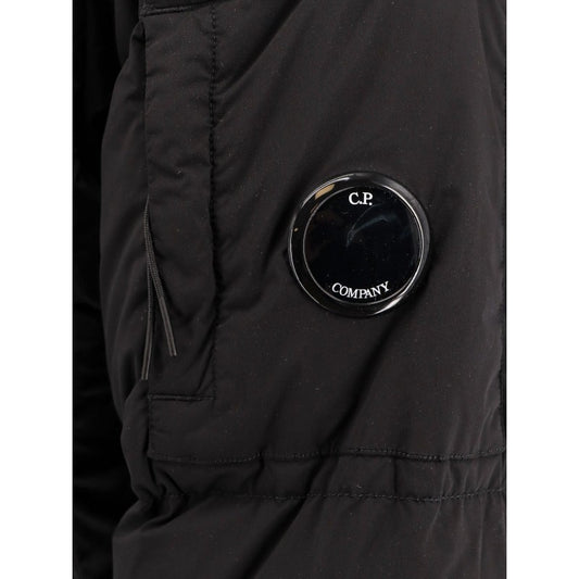 Close-up of the iconic CP Company lens logo detail on the sleeve of the Nycra-R jacket.
