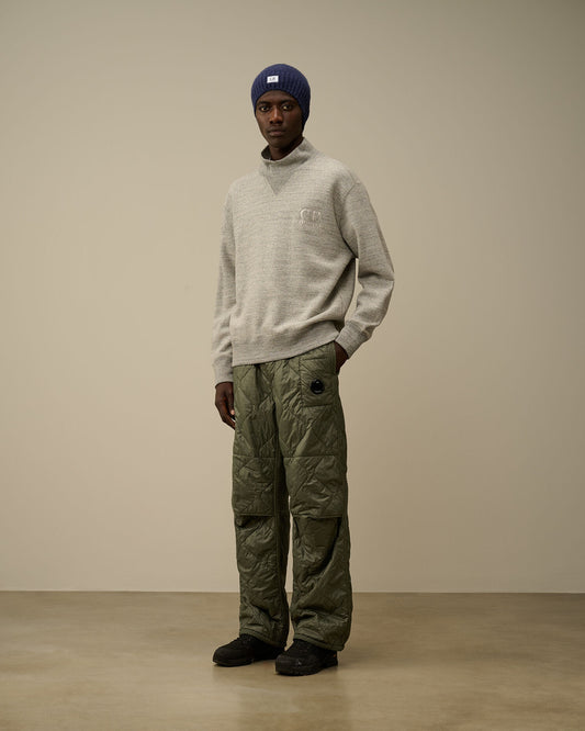  Full view of the CP Company quilted straight sweatpants in camo green.
