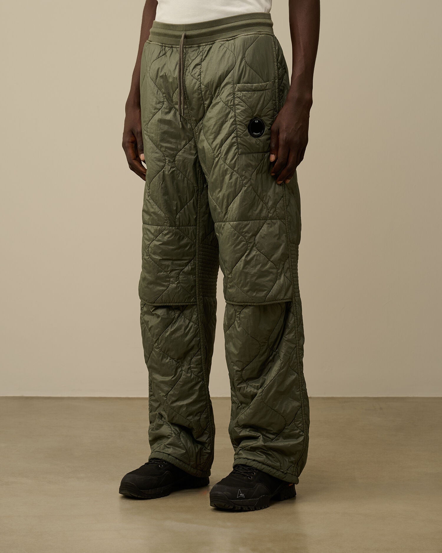 CP Company camo green quilted straight sweatpants, side view with drawstring