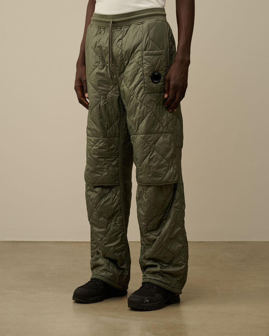 CP Company camo green quilted straight sweatpants, side view with drawstring