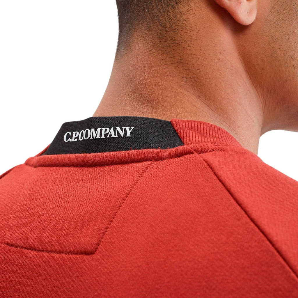 Embroidered CP Company logo detail on the back neck of the red fleece jumper