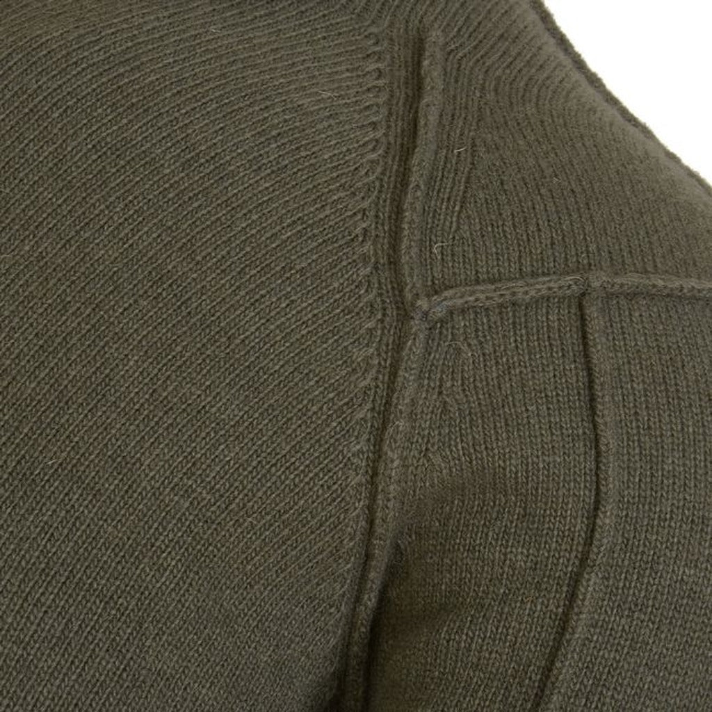 Detail of the knit texture on the CP Company green crew-neck jumper.
