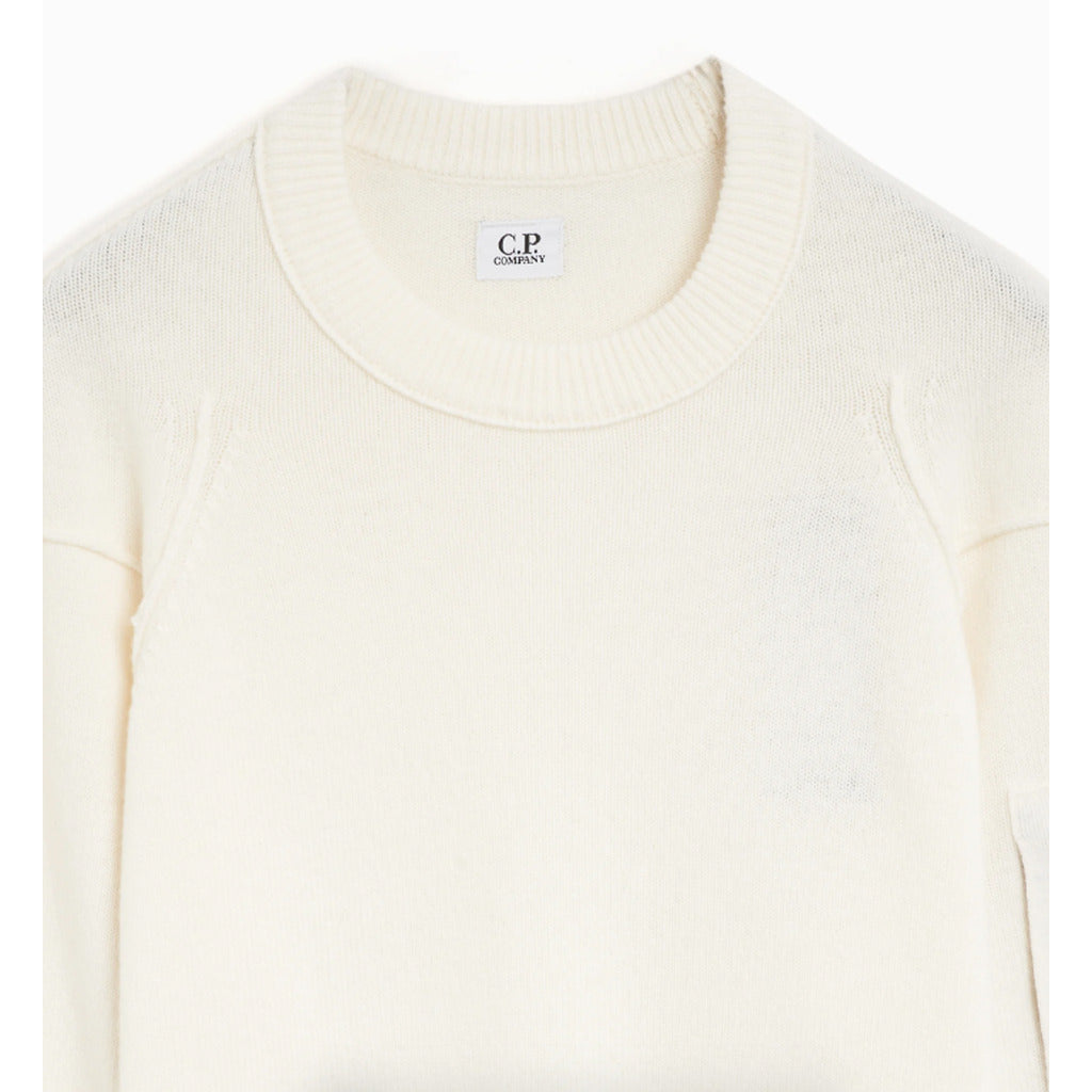 Detail of the knit texture on the CP Company white crew-neck jumper.
