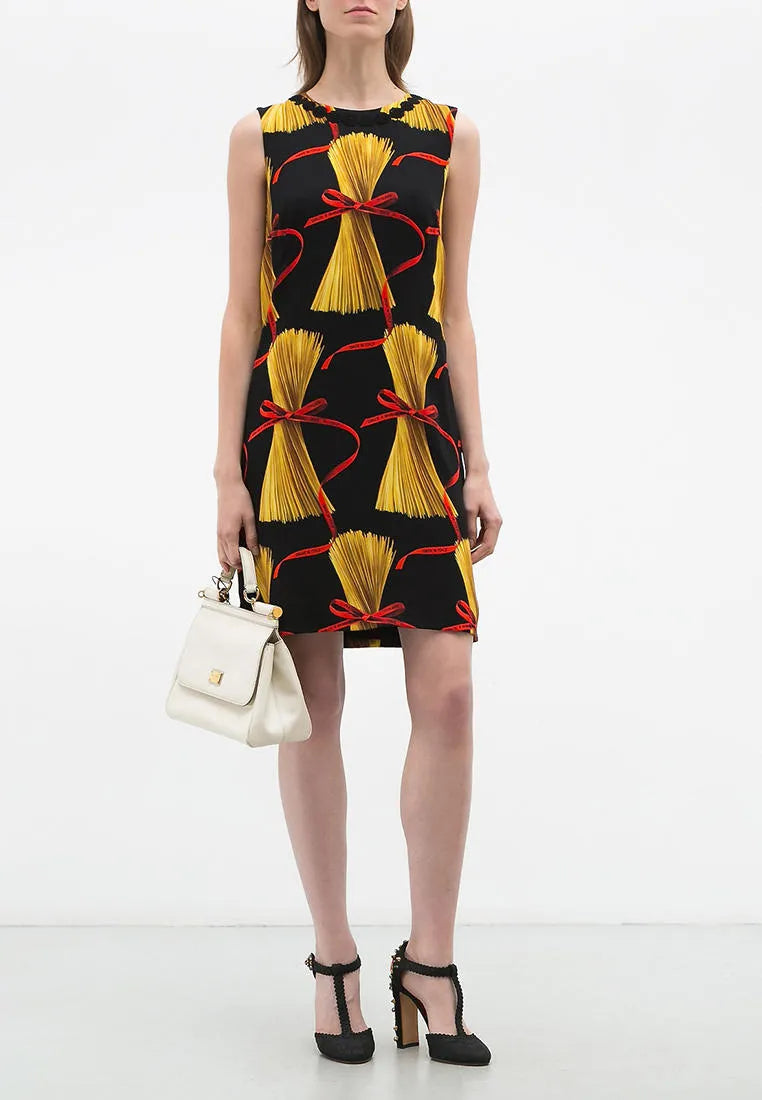 Model wearing the Dolce & Gabbana short sleeveless dress with pasta spaghetti print
