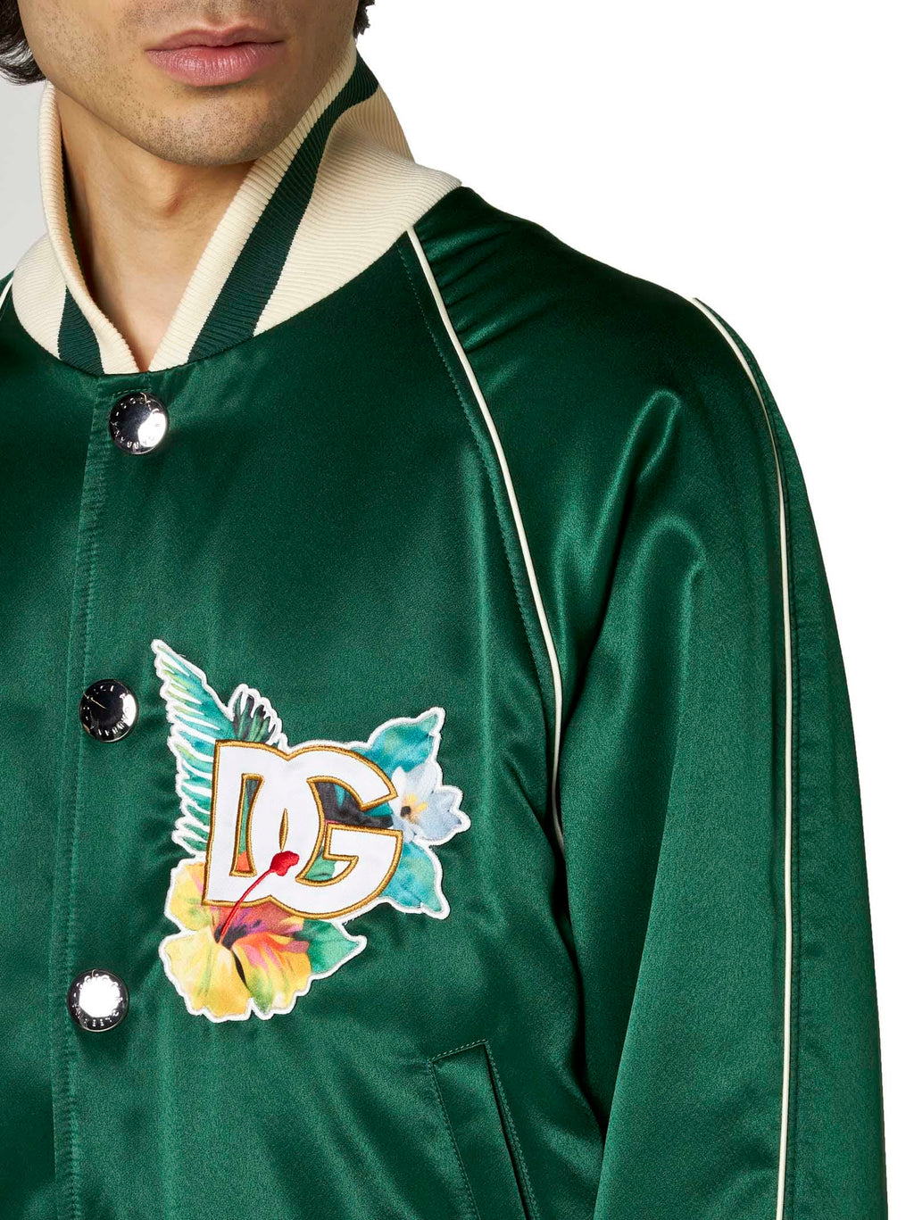 Close-up of the floral logo print on Dolce & Gabbana green satin bomber jacket
