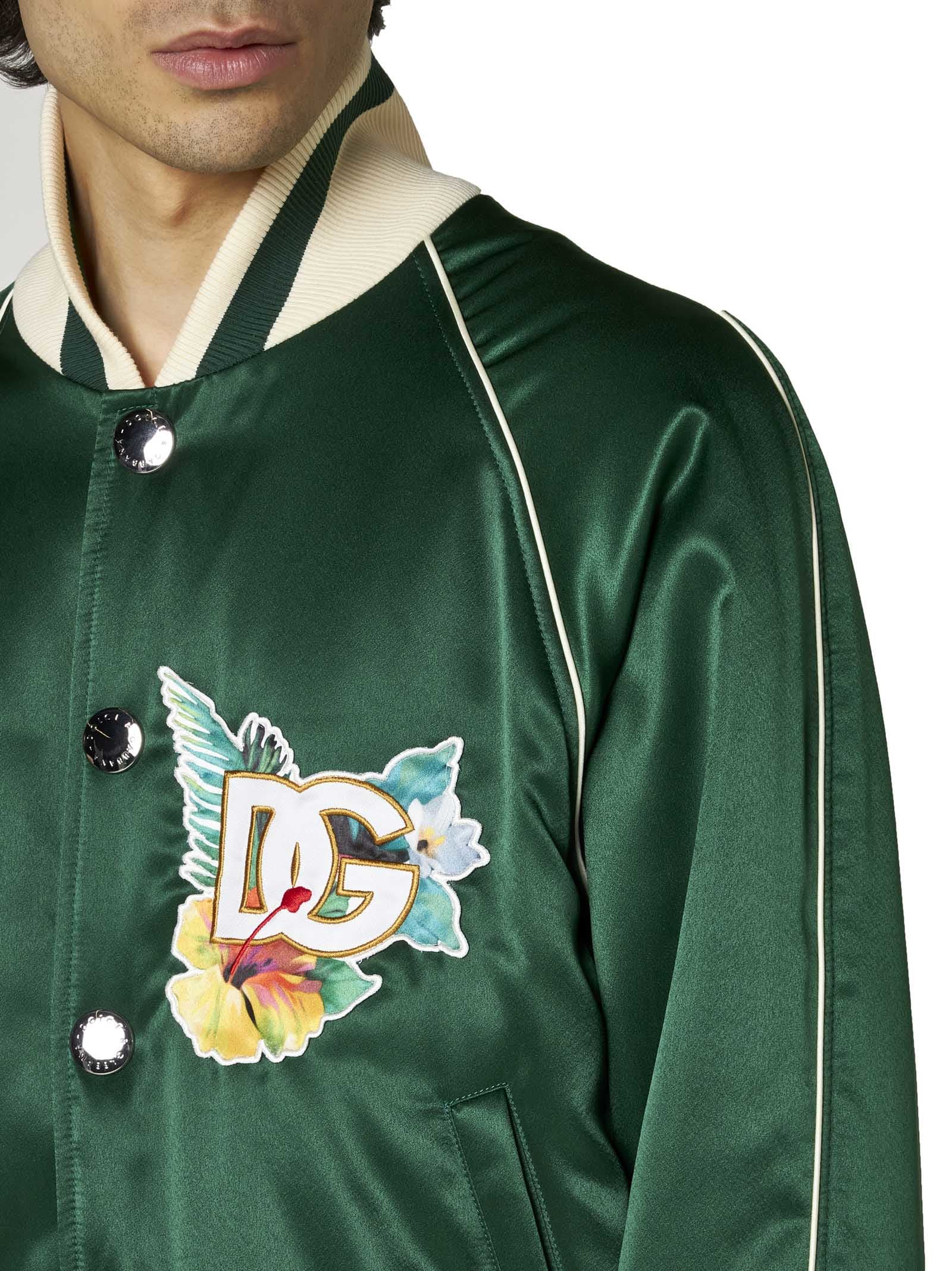 Close-up of the floral logo print on Dolce & Gabbana green satin bomber jacket
