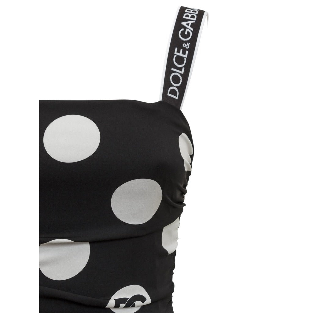 Close-up of the elastic shoulder straps with Dolce & Gabbana logo on polka dot dress
