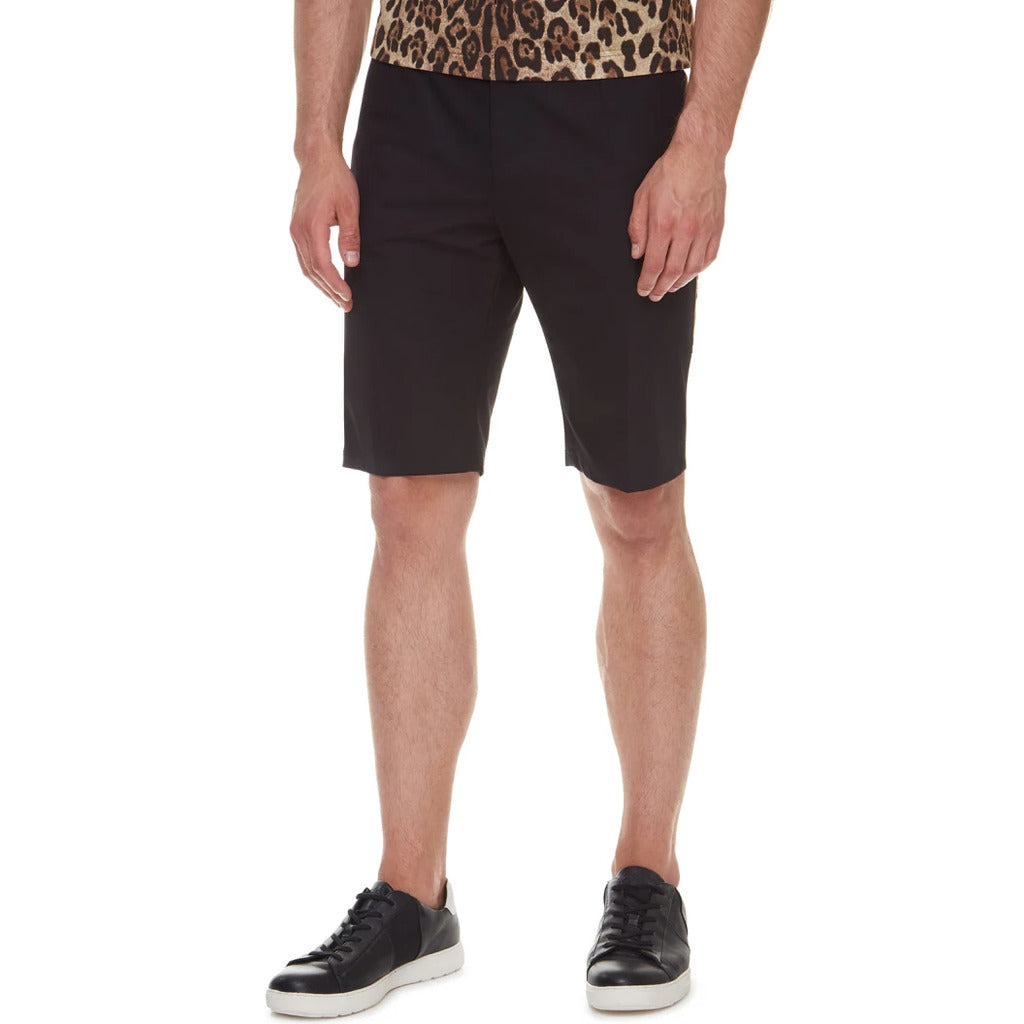 Full view of the Dolce & Gabbana black stretch cotton shorts with gold accents
