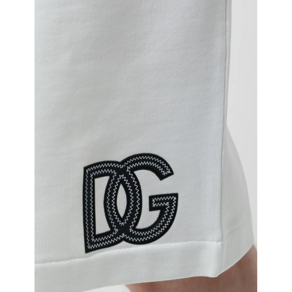 Detail of the DG logo patch on the bottom of Dolce & Gabbana white cotton shorts