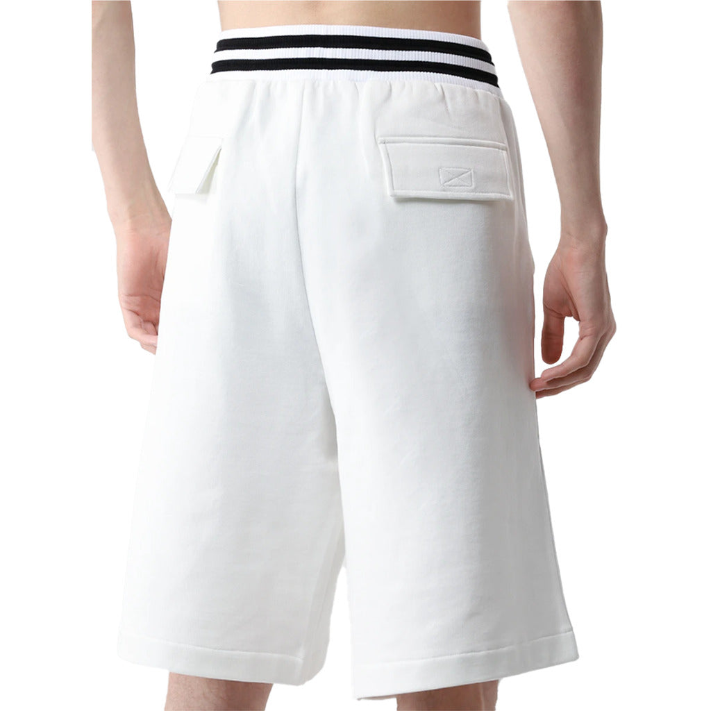 Back view of Dolce & Gabbana white Bermuda shorts showing velcro back pockets on model