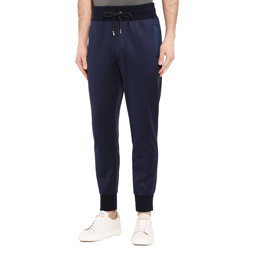 Model wearing the Dolce & Gabbana blue silk cotton blend logo sweatpants
