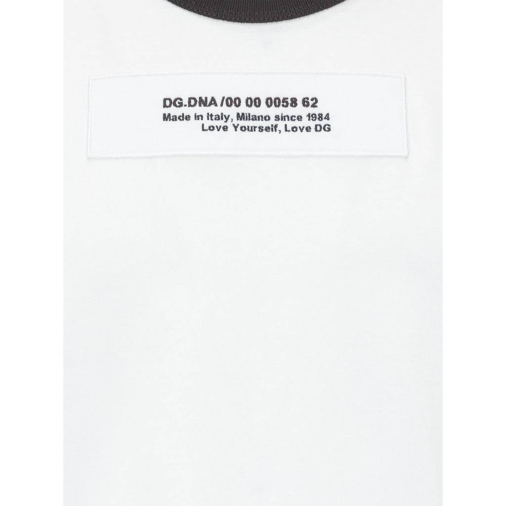 Close-up of the embroidered Dolce & Gabbana logo on the white t-shirt
