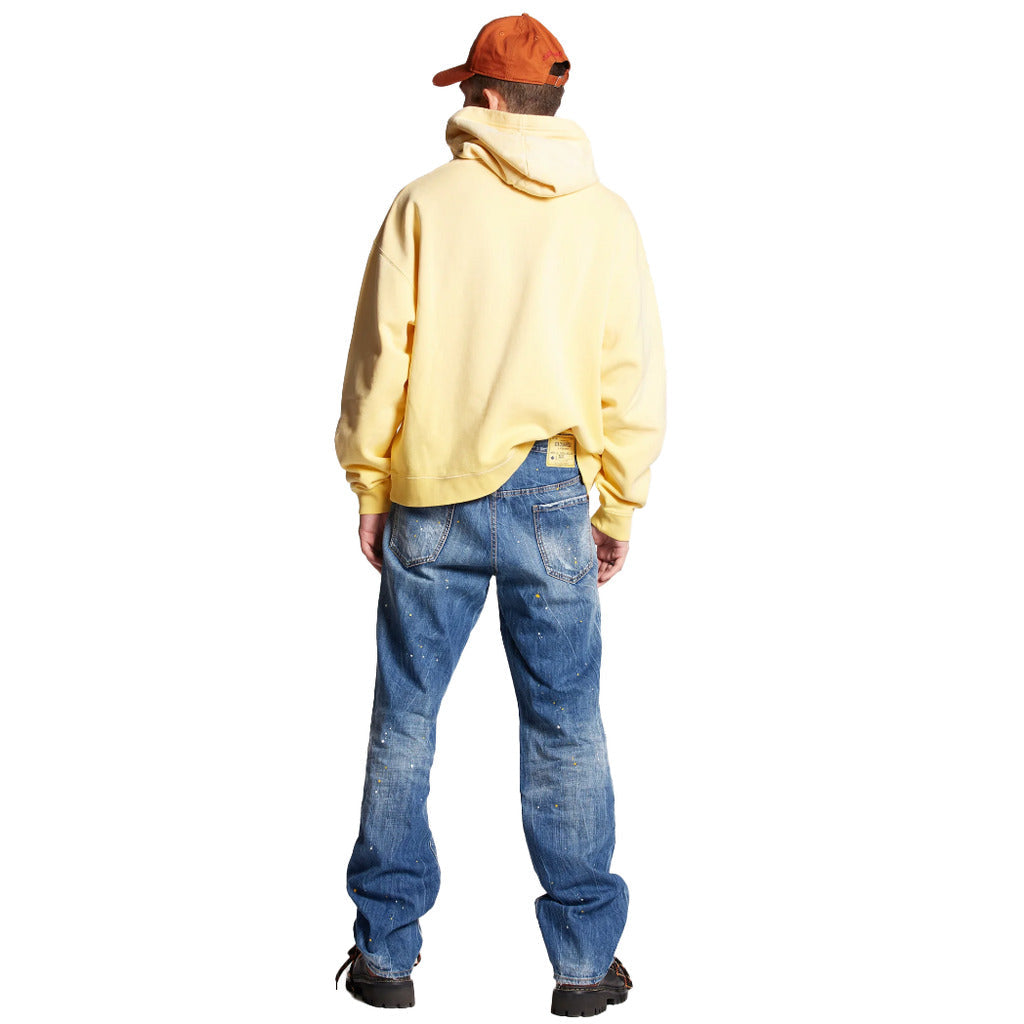 Back view of Dsquared2 Cool Guy blue jeans showing yellow logo patch and patches on model
