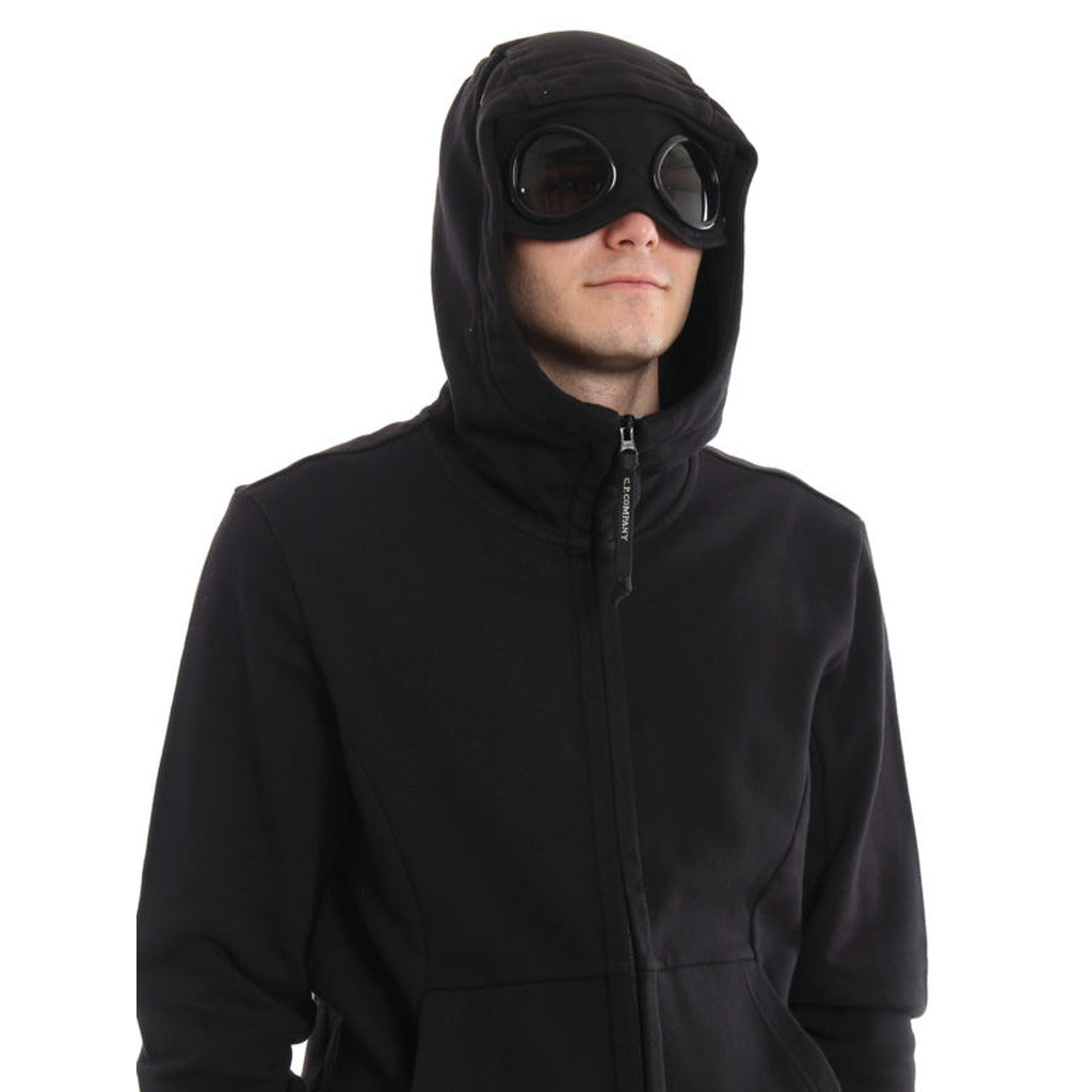 Model showcasing the regular fit of the CP Company black cotton Goggle jacket.
