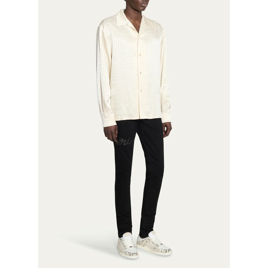 Model showcasing the normal fit of the Amiri MA Quad monogram long sleeve shirt.
