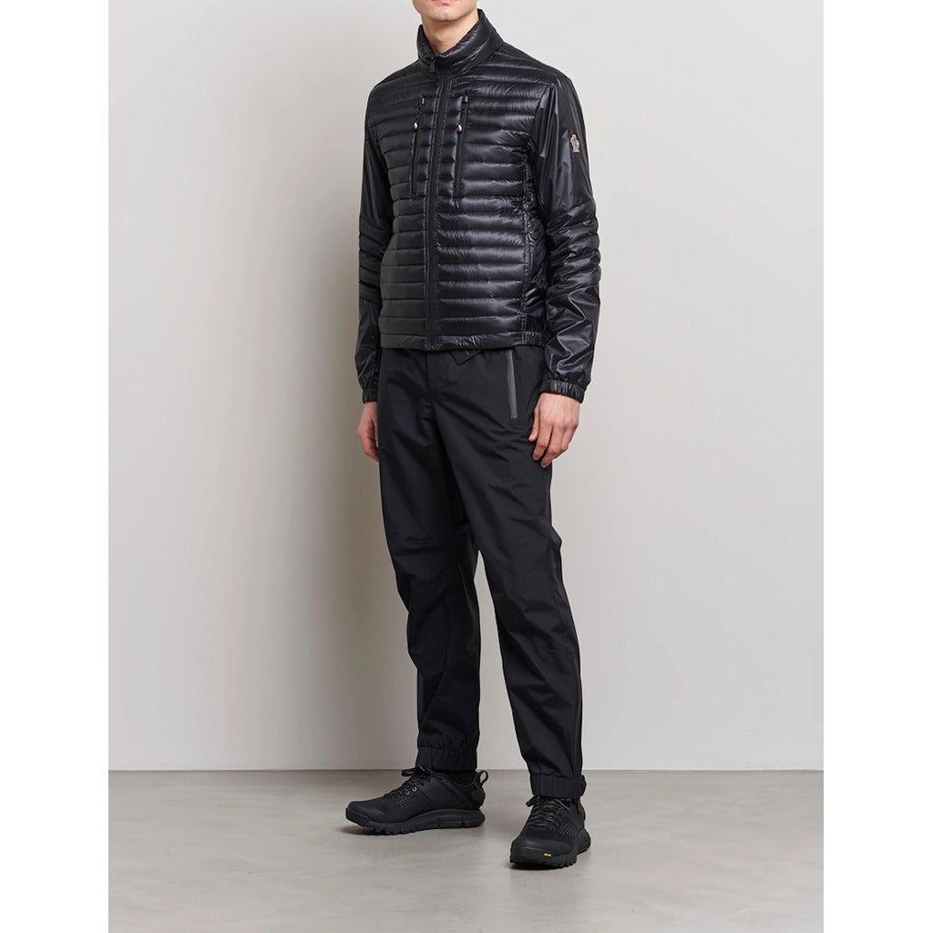Moncler Grenoble black high-shine padded down jacket angle view on model
