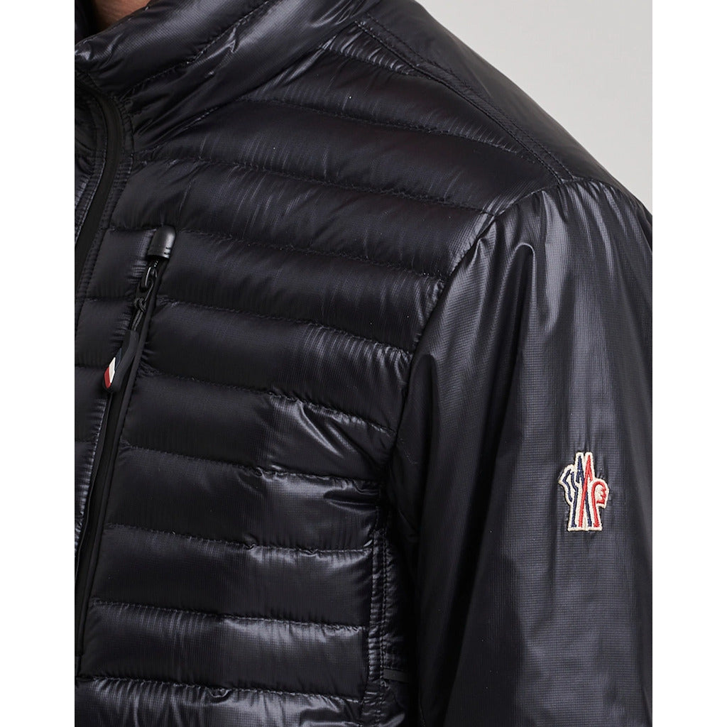 Close-up of the side and logo on the Moncler Grenoble black high-shine jacket
