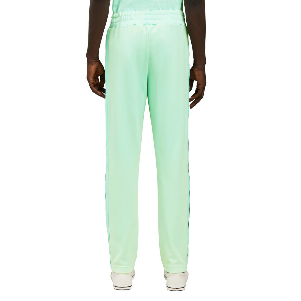 Back view of the Palm Angels neon green nylon trousers