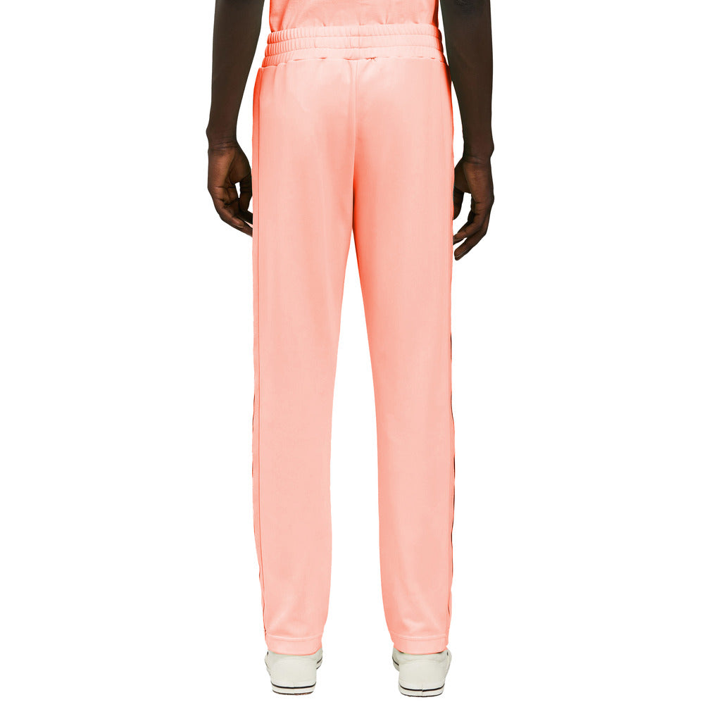 Back view of the Palm Angels neon orange nylon trousers
