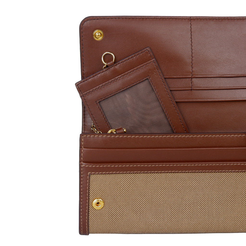 Open view showing the interior of the Prada rope and burnt brown flap wallet.
