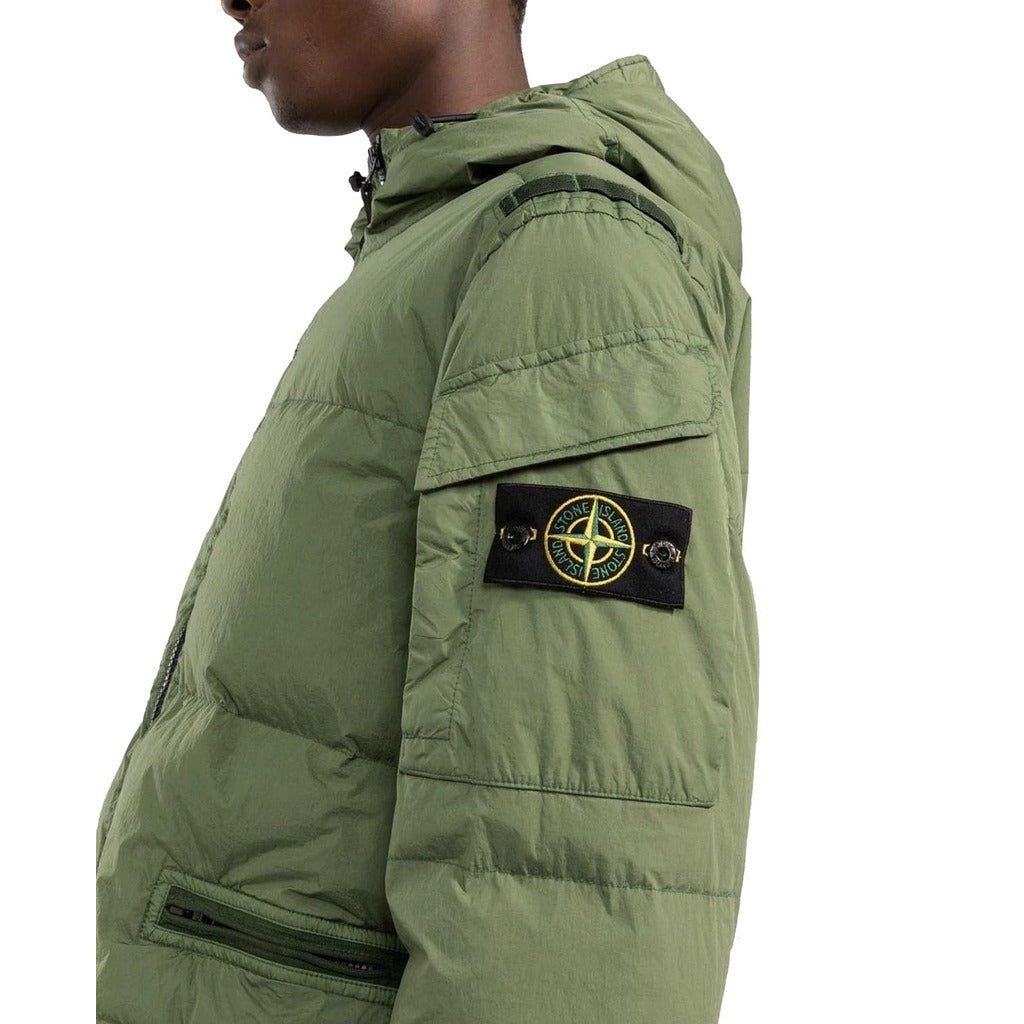 Close-up of the Stone Island badge and sleeve pocket on the green down jacket.

