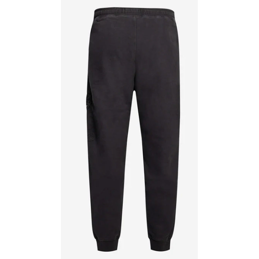 Detail of the waistband on the Stone Island black cotton sweatpants.

