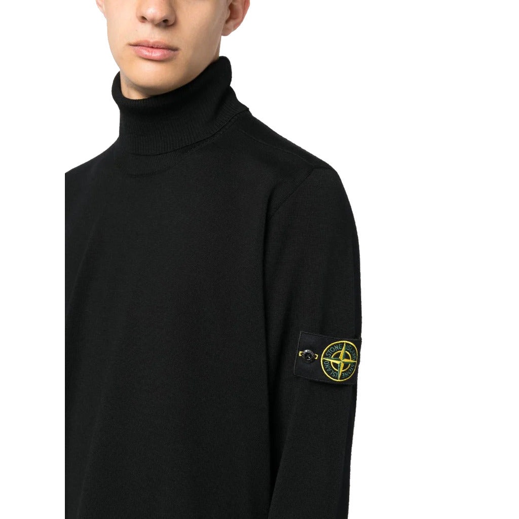 Close-up of the Stone Island Compass logo patch on the sleeve of the black wool jumper.
