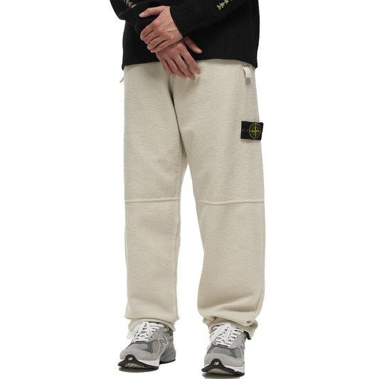 Stone Island creamy white cotton blend fleece sweatpants, front view.
