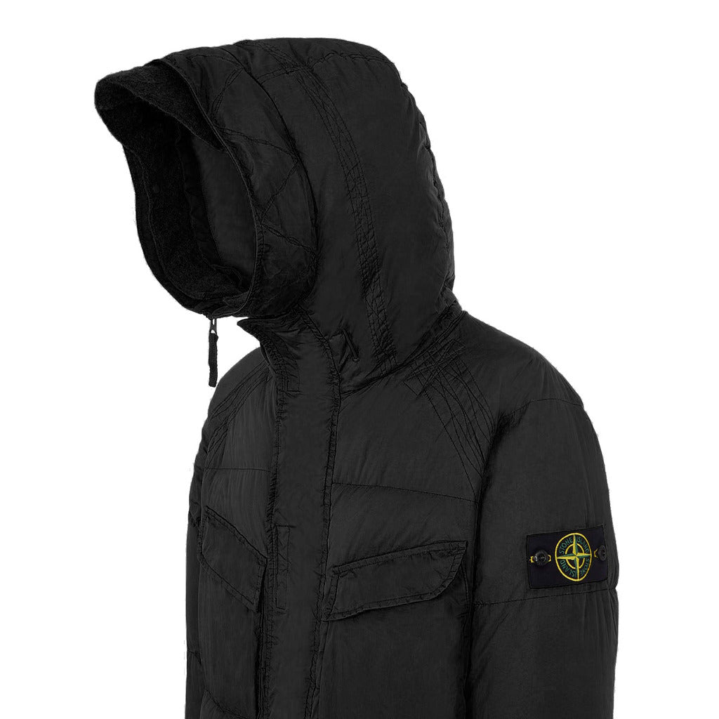 Close-up texture detail of the black Crinkle Reps nylon on the Stone Island coat.
