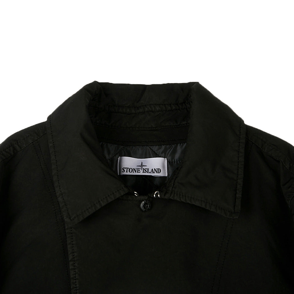 Close-up texture detail of the black David-TC fabric on the Stone Island coat.
