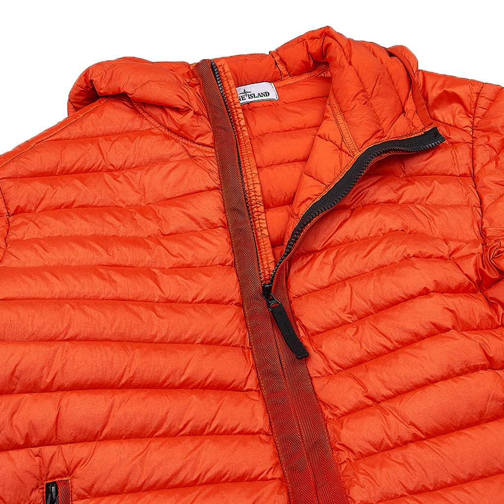 Side zipper pocket detail on the Stone Island orange duck down padded jacket.
