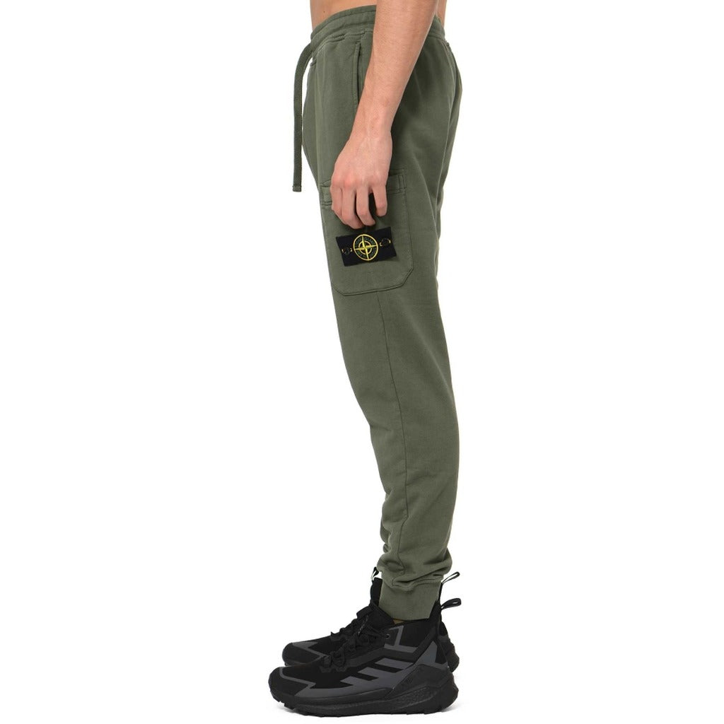 Close-up of Stone Island badge on the zip leg pocket of the green joggers.
