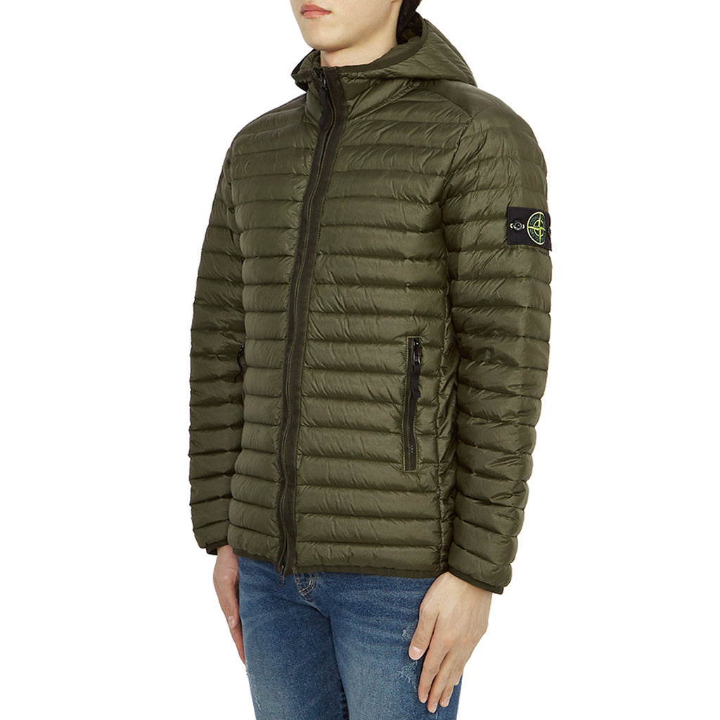 Close-up of the Stone Island logo patch on the sleeve of the green down jacket.

