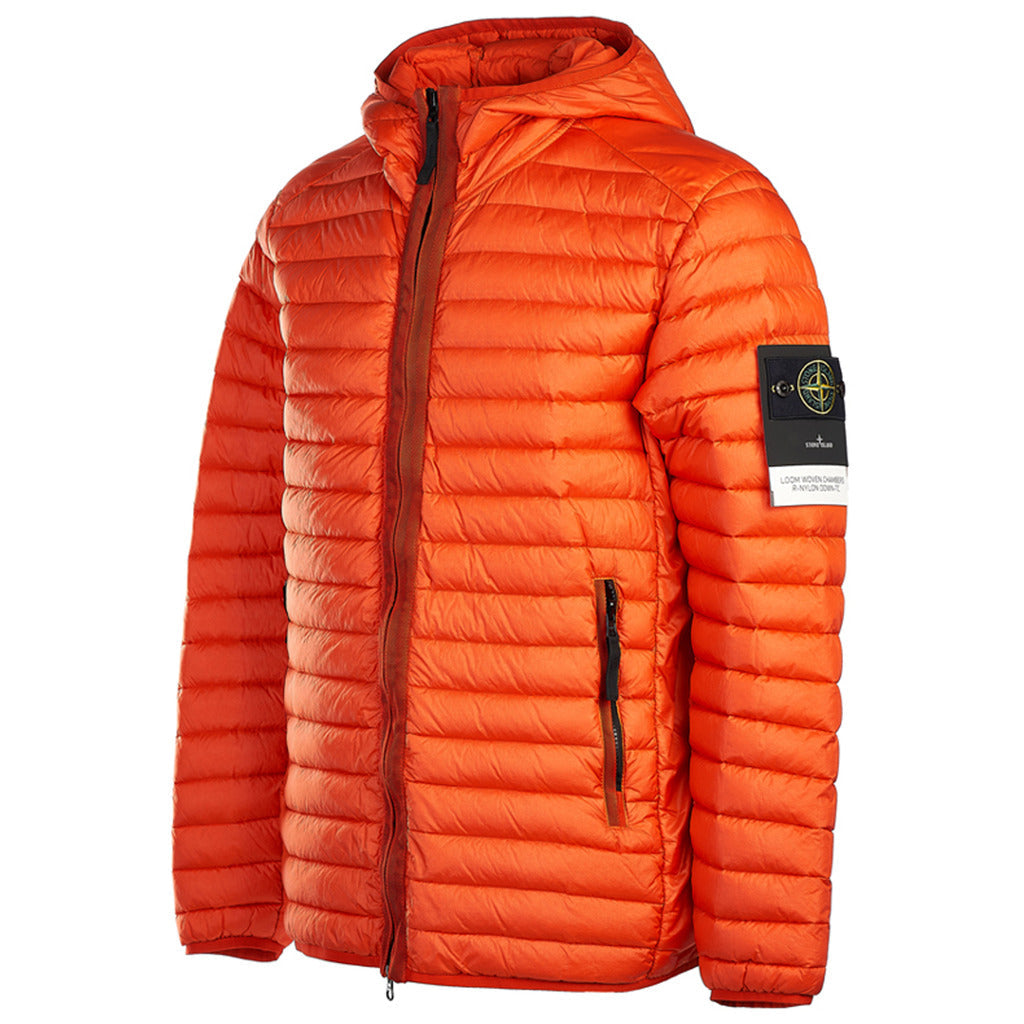 Close-up of the Stone Island logo patch on the sleeve of the orange down jacket