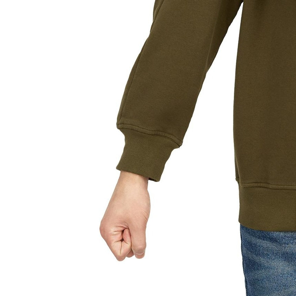 Close-up of the ribbed cuffs and hem on the Stone Island olive jumper.
