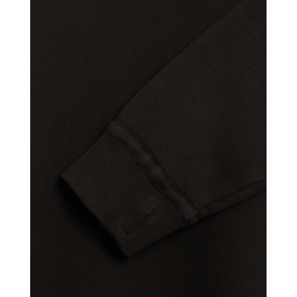 Close-up of the ribbed cuffs and bottom band on the organic fleece sweatshirt.
