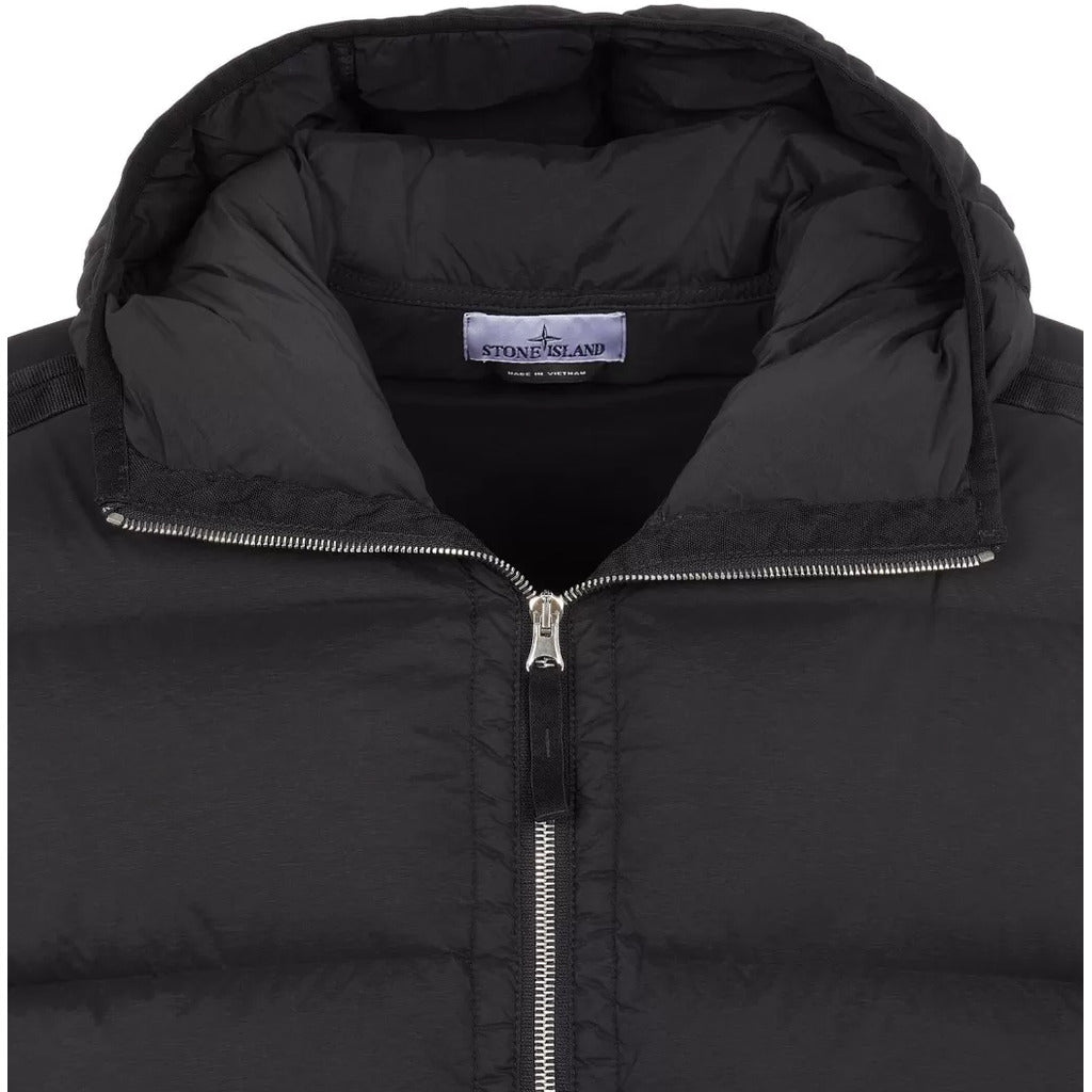 Close-up of the vertical zip pocket on the Stone Island black seamless down jacket.
