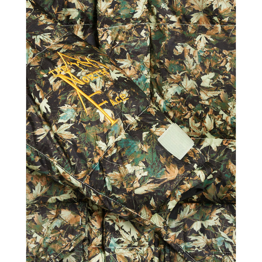 Texture close-up of the green camouflage polyester-nylon blend fabric on the parka.